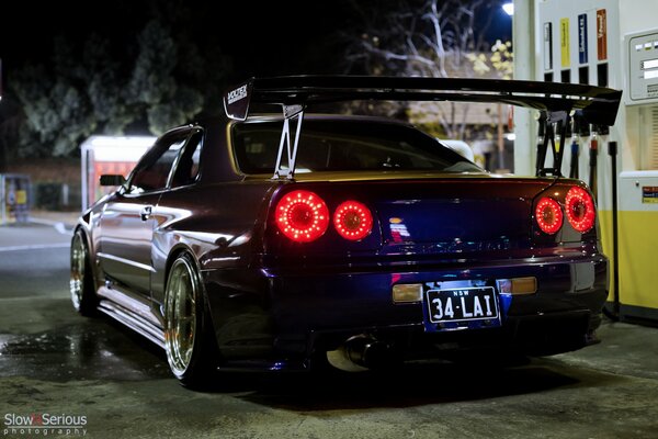 Nissan Skyline at a gas station at night rear view