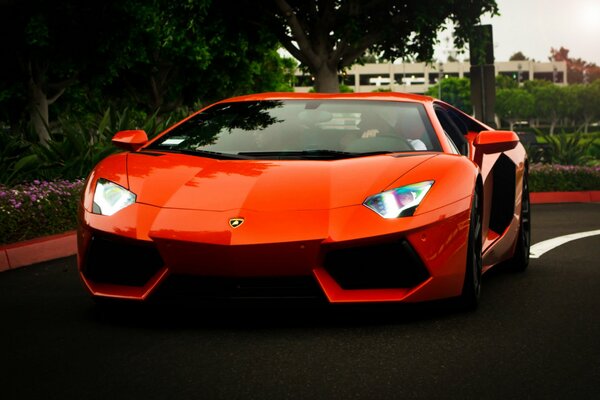 Orange Lambargini rides on a city road