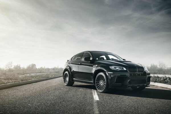 Black bmw x6m car driving on the road