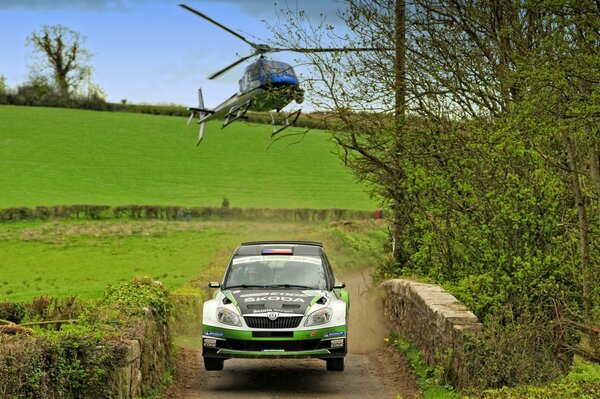 A helicopter is chasing an unusual white car