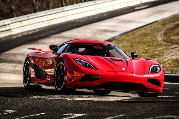 Red stylish agera r on the background of the highway