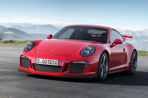 On the highway, the legendary Porsche 911, red color, front view