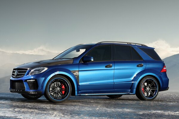 A blue Mercedes car in an icy parking lot