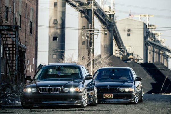 Two dark BMW cars in the city