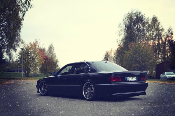 Black car on the autumn street of the city