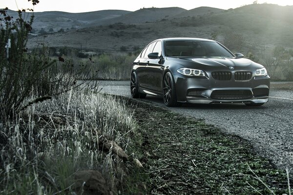 Black BMW in a turn at the curb