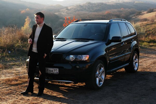 vladimir vdovichenkov on the background of bmw x5 from the movie Boomer 2 