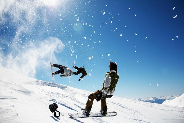 Сноубордист на снежном склоне совершают трюки