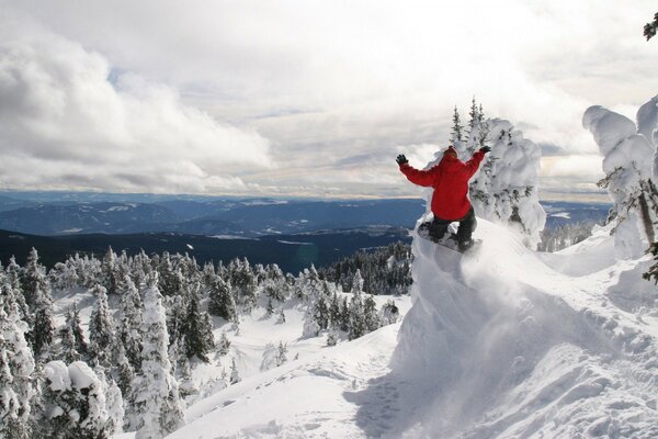 Snowboarder in a red jacket in the mountains