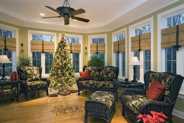 Sala de estar con muebles tapizados y un hermoso árbol de Navidad