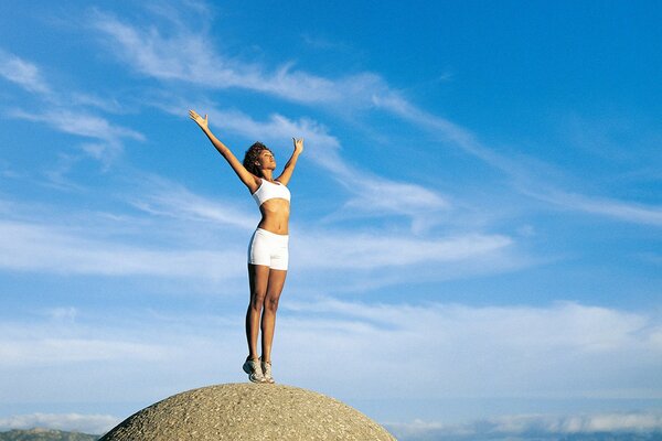 A girl and happiness on a stone