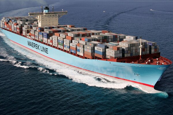 A huge container ship is sailing on the blue sea