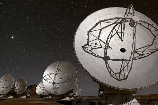 Satellite dishes on the background of the starry sky