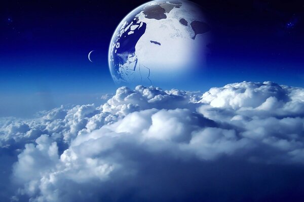 Изображение планеты земля на фоне облаков из космоса с месяцем