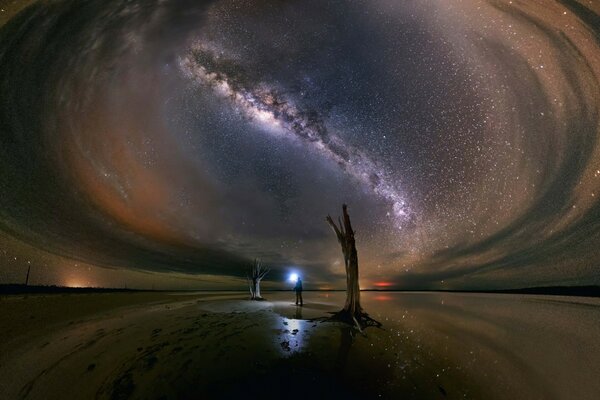 A man with a lantern on the background of the heavenly glow