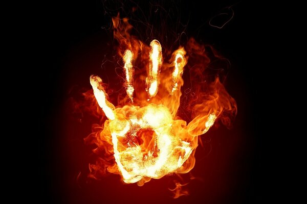 A flaming hand on a black background