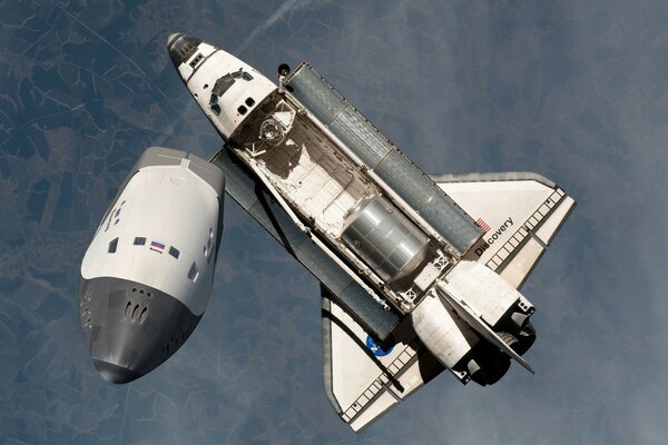 Space shuttle hovers in the atmosphere