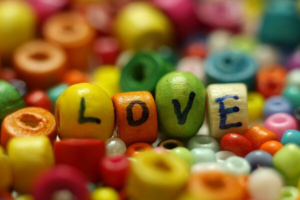 Multicolored beads. The inscription love on beads