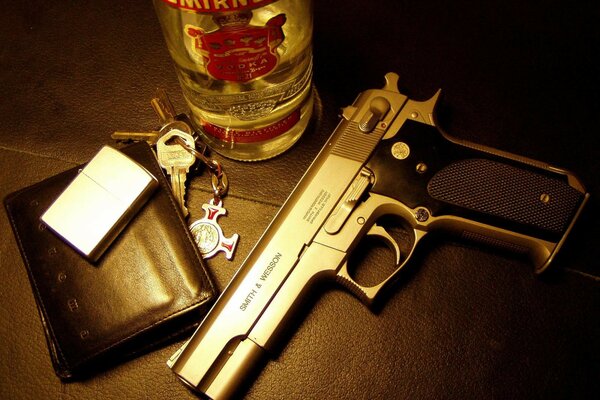 On the table there is a gun, a purse, keys and vodka