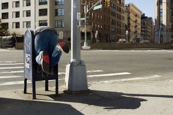 Feet in a trash can on a New York street