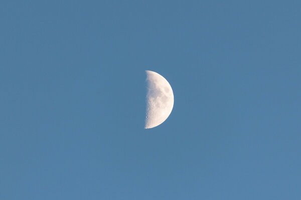 Half moon at sunset cloudless sky crescent moon comes out
