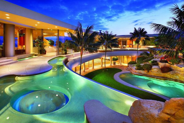 Blue sunset by the pool with palm trees