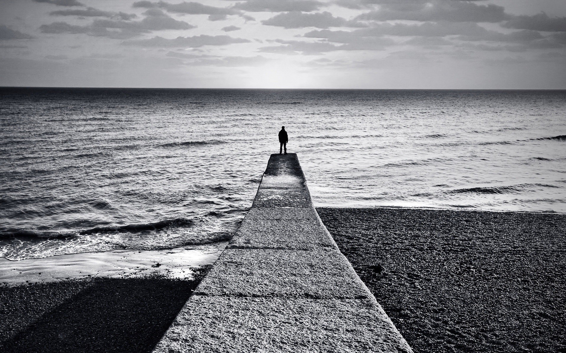 black and white horizon man pier beach sea