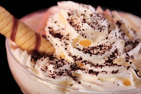 Ice cream with whipped cream and a waffle stick