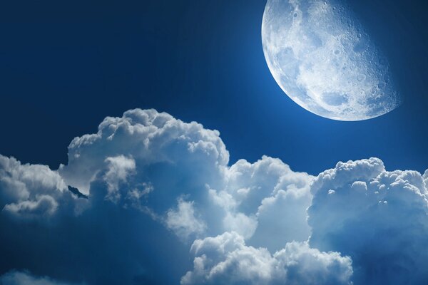 Blue moon in the embrace of clouds