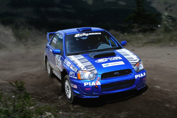 The blue Subaru impreza unfolds at speed