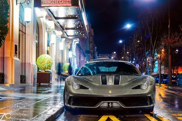 Paris street after the rain. Ferrari car on the night street