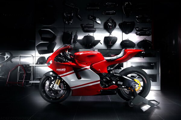 Ducati sport bike with a spectacular understretch on the background of a rack with spare parts