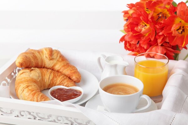 Breakfast in bed with croissants and jam