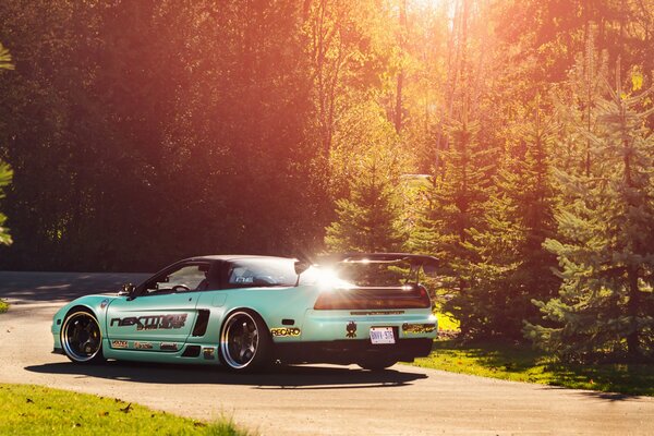 Tuned honda nsx in the rays of the forest sun