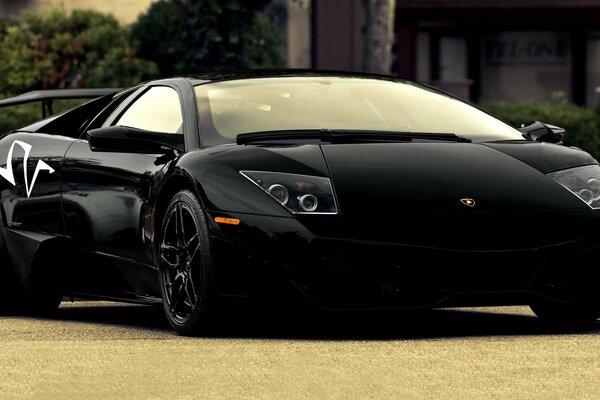 In a black lamborghini with beautiful hoods