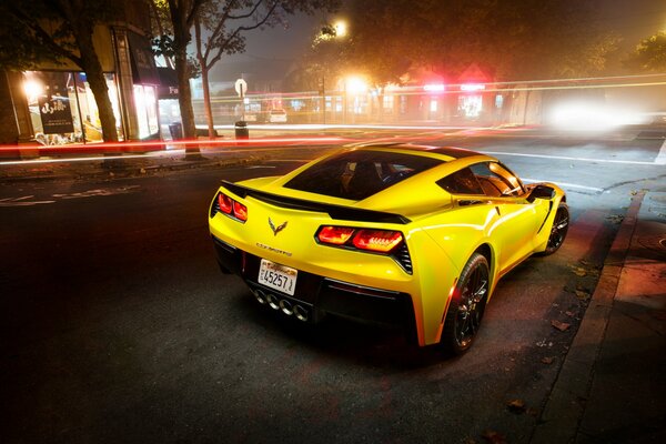 A yellow sports car drives around the city