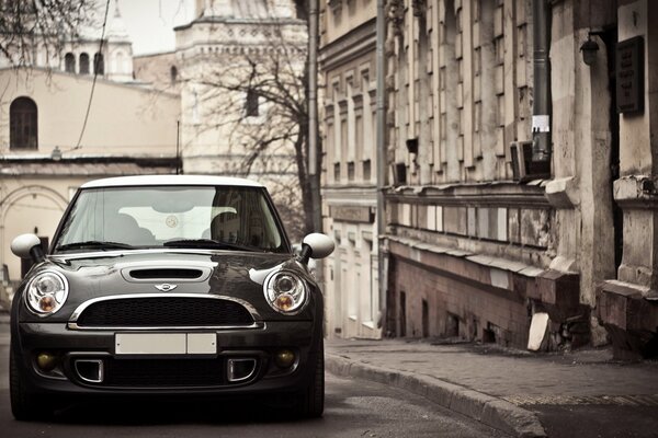 Mini cooper on the background of the autumn landscape