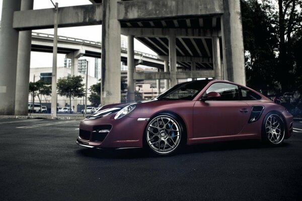 Purple car under the bridge