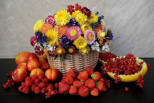 A bouquet of bright flowers in a basket and berries