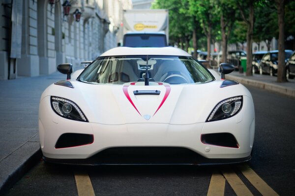 A white sports car on a city street