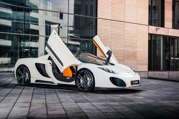 White supercar on the background of a high-rise building