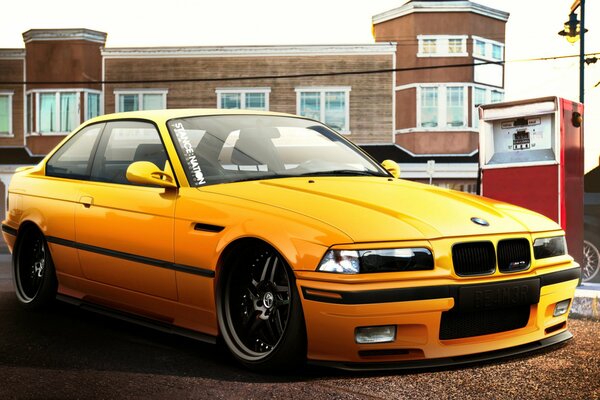 BMW jaune tuning avec suspension abaissée