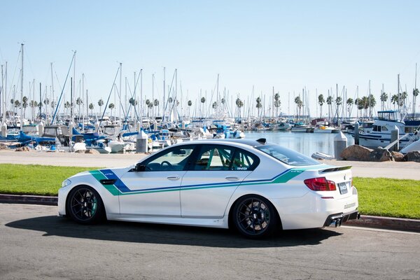 bmw sports car on the background of a berth with yachts