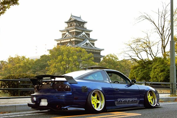 A tuned car against the background of a Chinese house