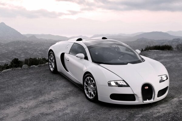 White luxury sports car in the mountains