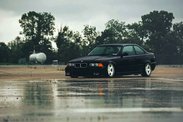 Black BMW in the rain