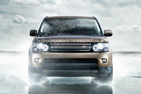 The range Rover car rides through puddles