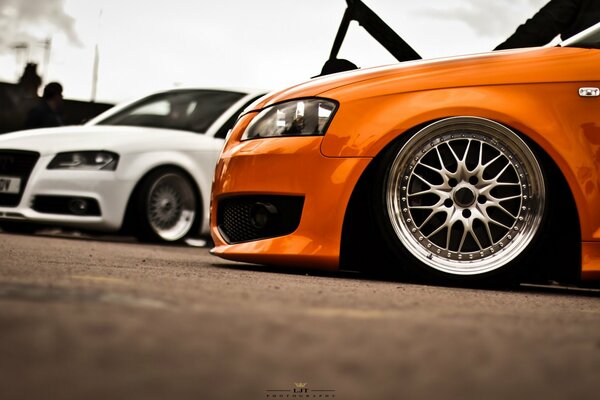 Two audis of different shades - orange and white