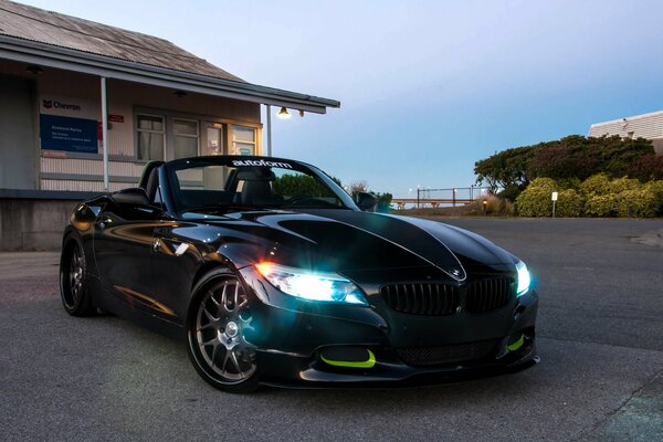 Black BMW against the sky and trees