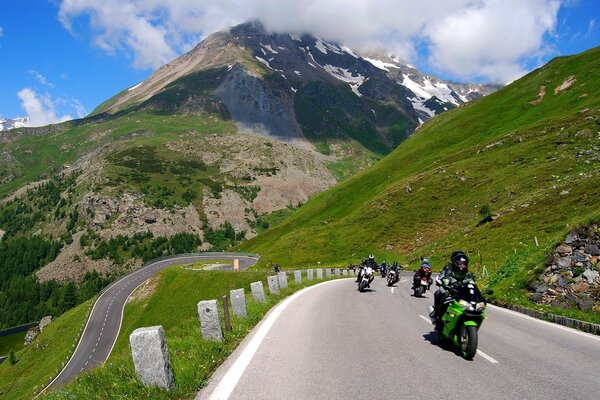 Bikers in the mountains on the road go fast